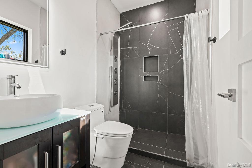 5 Bluebird Road Monsey, NY 10952 - Photo 30 of 50 a bathroom with a shower a toilet and a sink