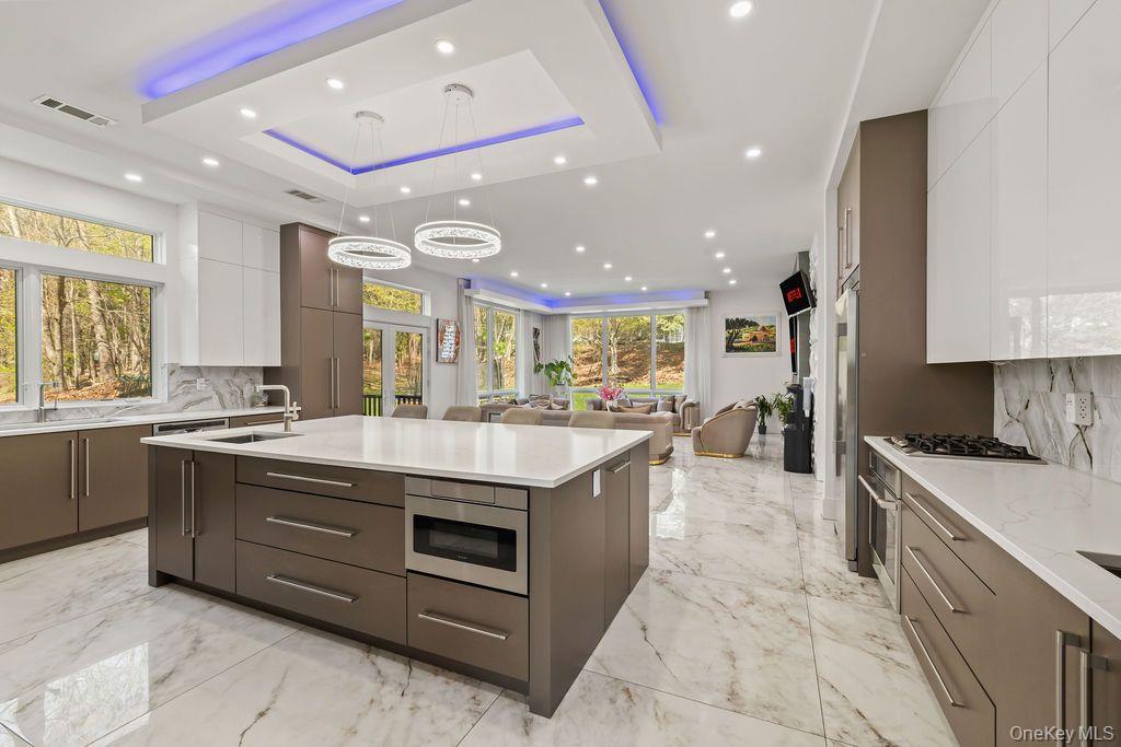 5 Bluebird Road Monsey, NY 10952 - Photo 7 of 50 a large kitchen with stainless steel appliances granite countertop a large stove a sink and a refrigerator