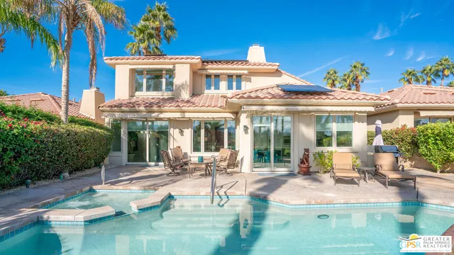 a living room with furniture a fireplace and a potted plant