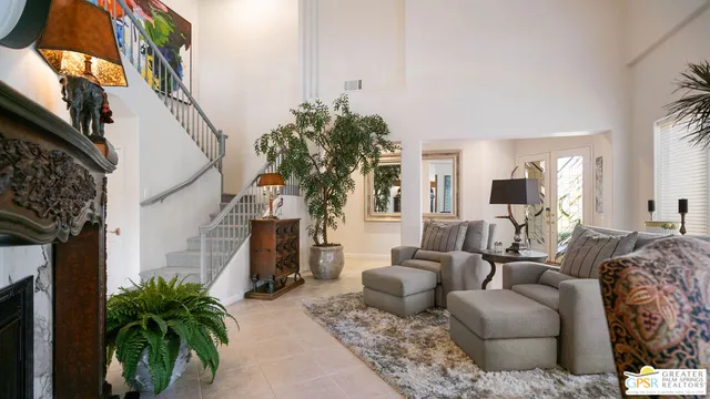 a view of spacious bathroom with a potted plant on the counter and mirror
