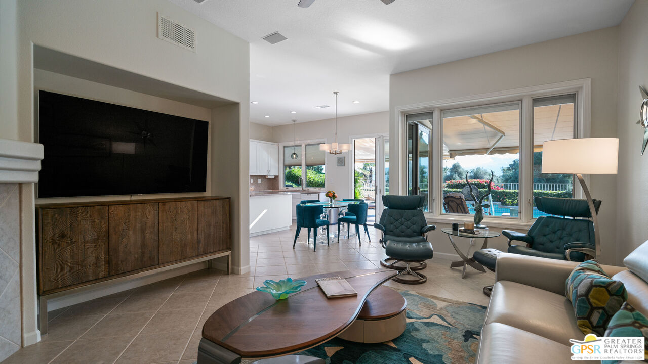 72 North Kavenish Drive Rancho Mirage, CA 92270 - Photo 15 of 73 a living room with furniture a flat screen tv and a floor to ceiling window