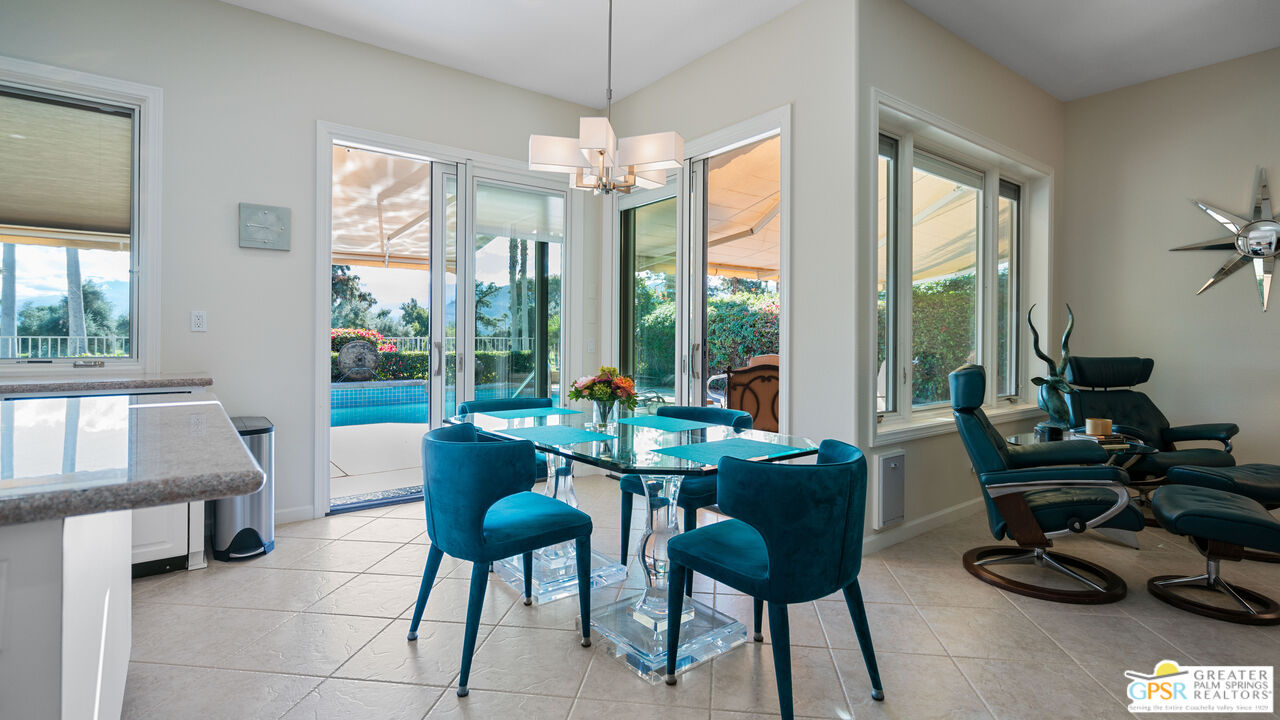 72 North Kavenish Drive Rancho Mirage, CA 92270 - Photo 16 of 73 a dining room with furniture a chandelier and wooden floor