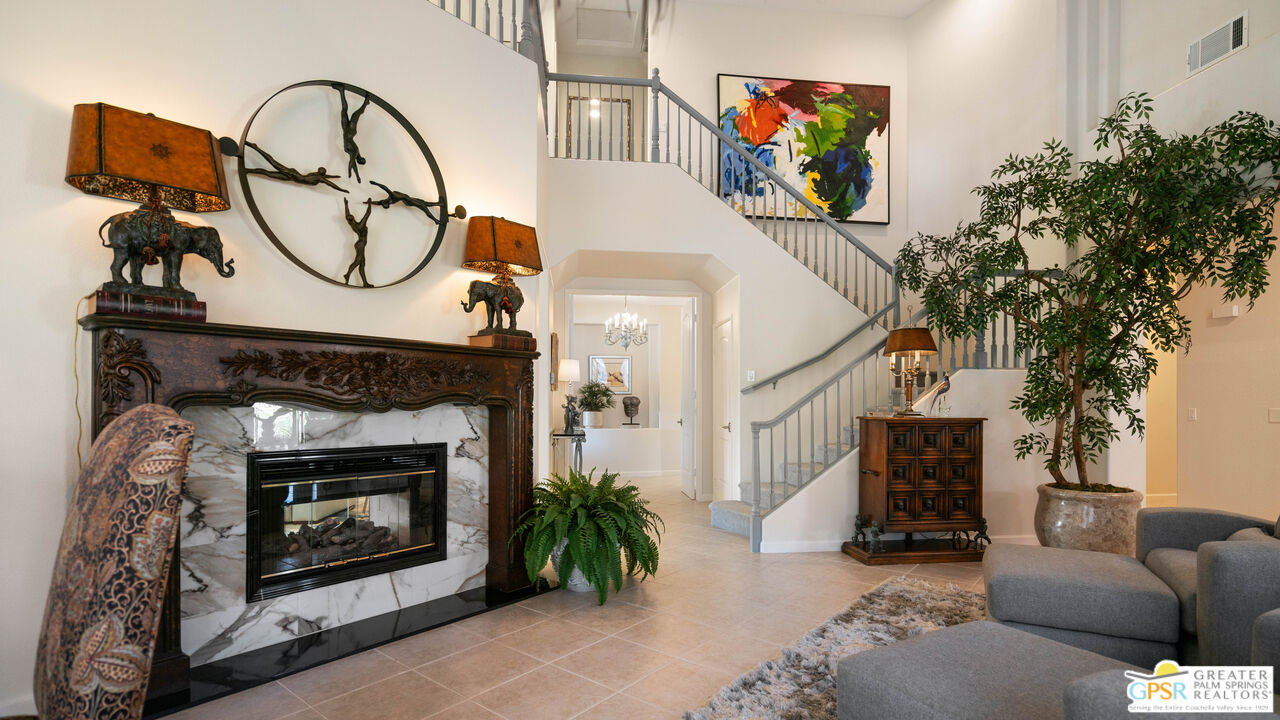 72 North Kavenish Drive Rancho Mirage, CA 92270 - Photo 2 of 73 a living room with furniture a fireplace and a potted plant