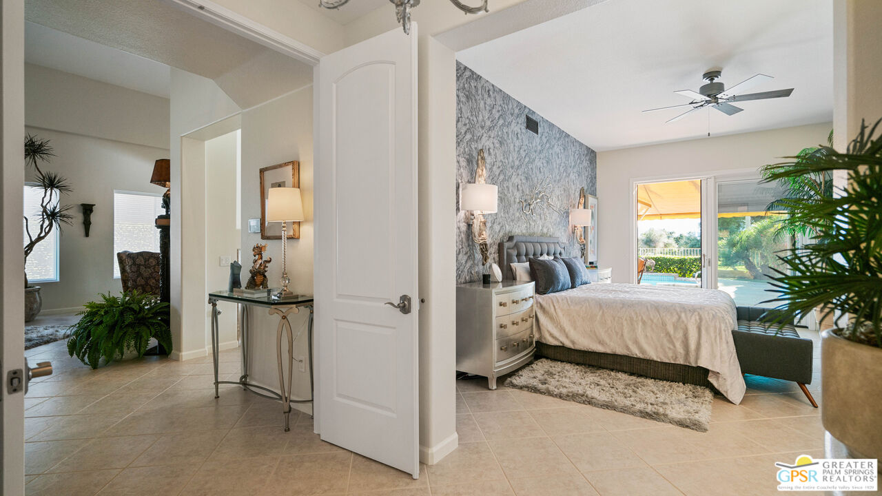 72 North Kavenish Drive Rancho Mirage, CA 92270 - Photo 21 of 73 a spacious bedroom with a bed and a potted plant