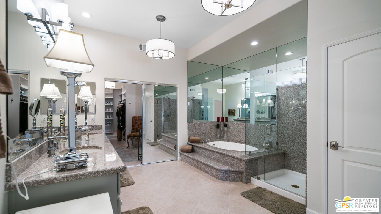 72 North Kavenish Drive Rancho Mirage, CA 92270 - Photo 26 of 73 a bathroom with a tub sink shower and mirror