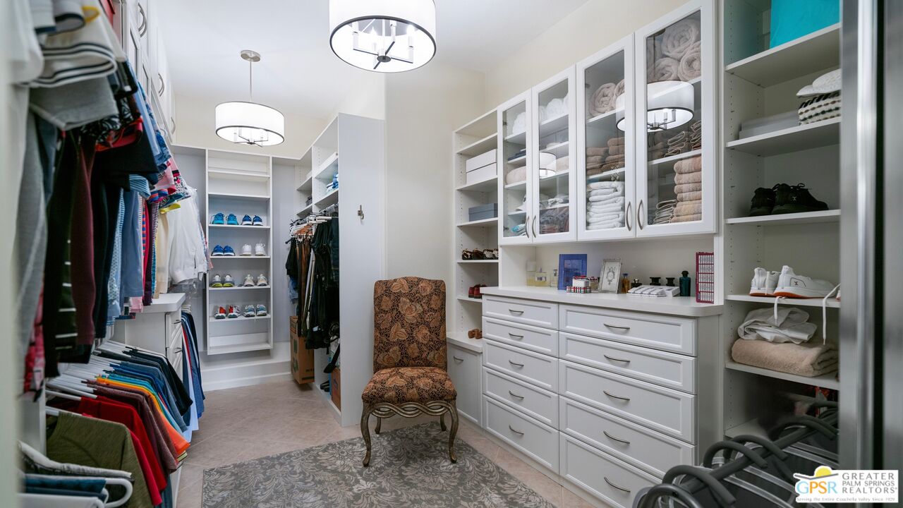 72 North Kavenish Drive Rancho Mirage, CA 92270 - Photo 29 of 73 a view of walk in closet with clothes and shoes