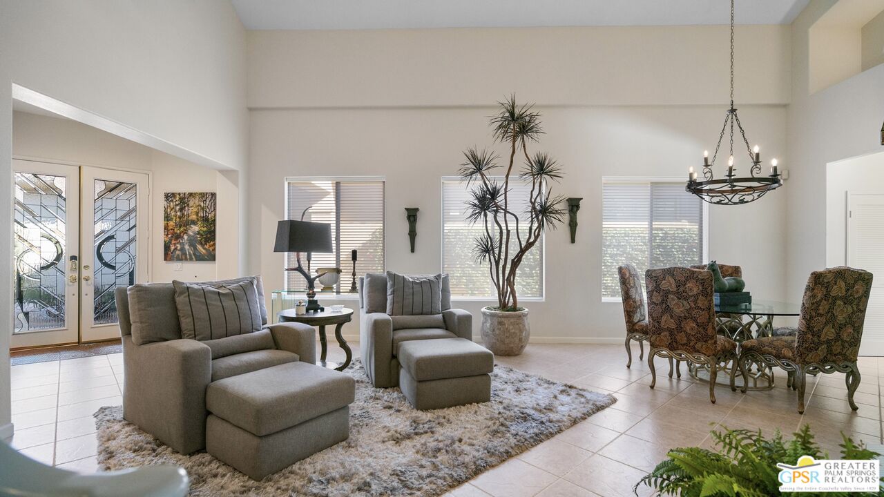 72 North Kavenish Drive Rancho Mirage, CA 92270 - Photo 3 of 73 a living room with furniture and a chandelier