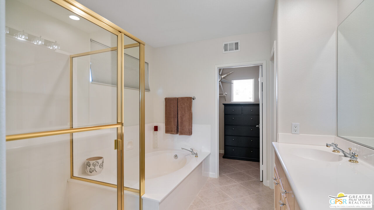 72 North Kavenish Drive Rancho Mirage, CA 92270 - Photo 37 of 73 a bathroom with a tub a sink and mirrors