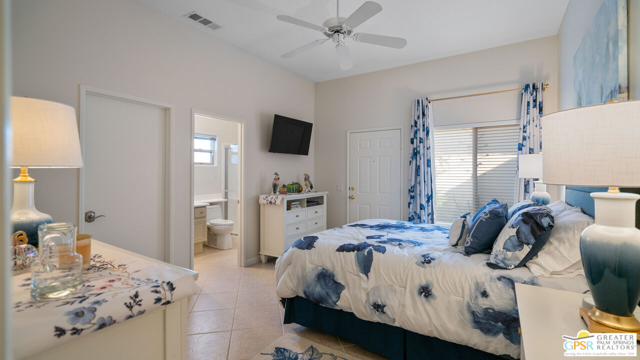 72 North Kavenish Drive Rancho Mirage, CA 92270 - Photo 41 of 73 a bedroom with a bed and a flat tv screen on dresser