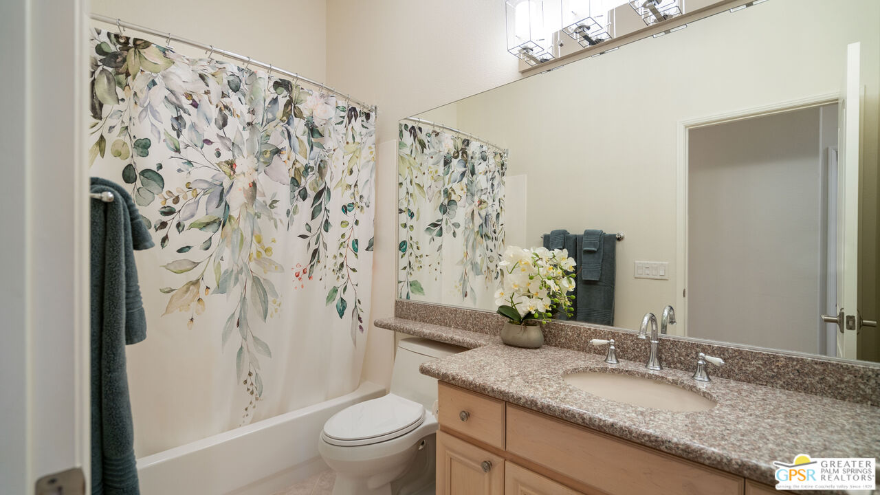 72 North Kavenish Drive Rancho Mirage, CA 92270 - Photo 48 of 73 a bathroom with a granite countertop sink and a mirror