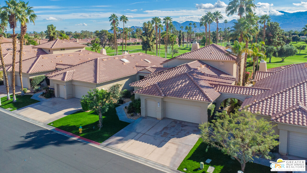 72 North Kavenish Drive Rancho Mirage, CA 92270 - Photo 51 of 73 a front view of a house with a yard and outdoor seating