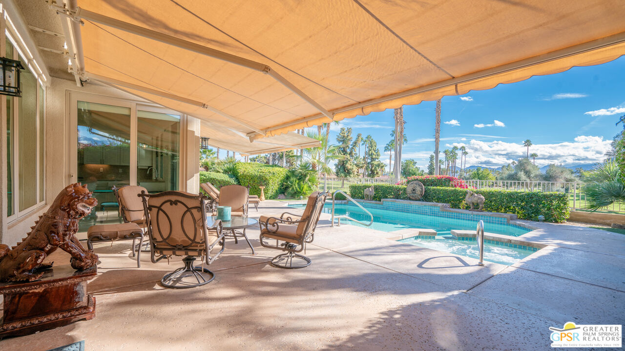 72 North Kavenish Drive Rancho Mirage, CA 92270 - Photo 55 of 73 a view of a patio with a dining table and chairs with wooden floor and fence