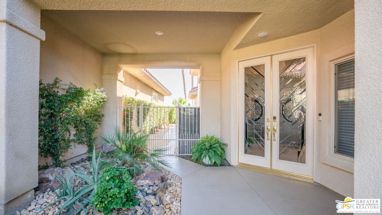 72 North Kavenish Drive Rancho Mirage, CA 92270 - Photo 9 of 73 a house with potted plants in front of door
