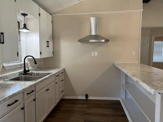 a view of room with window and wooden floor