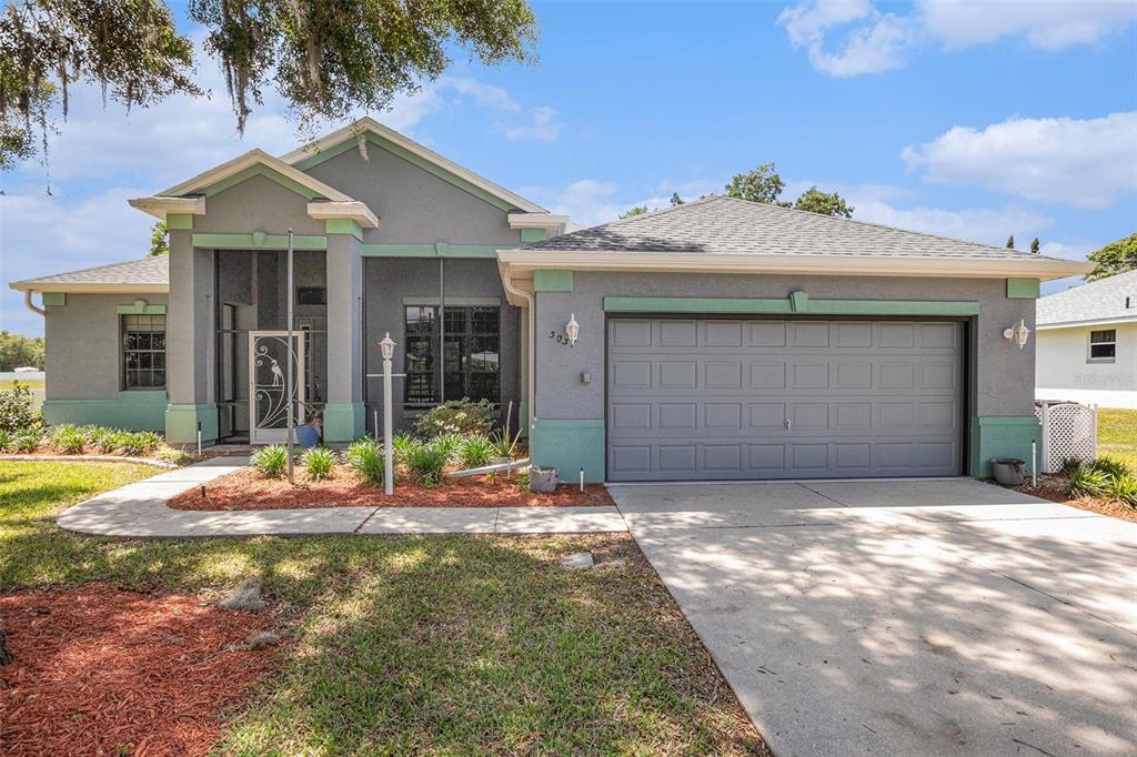 3037 North Folkestone Loop Hernando, FL 34442 - Photo 1 of 1 a front view of a house with garden