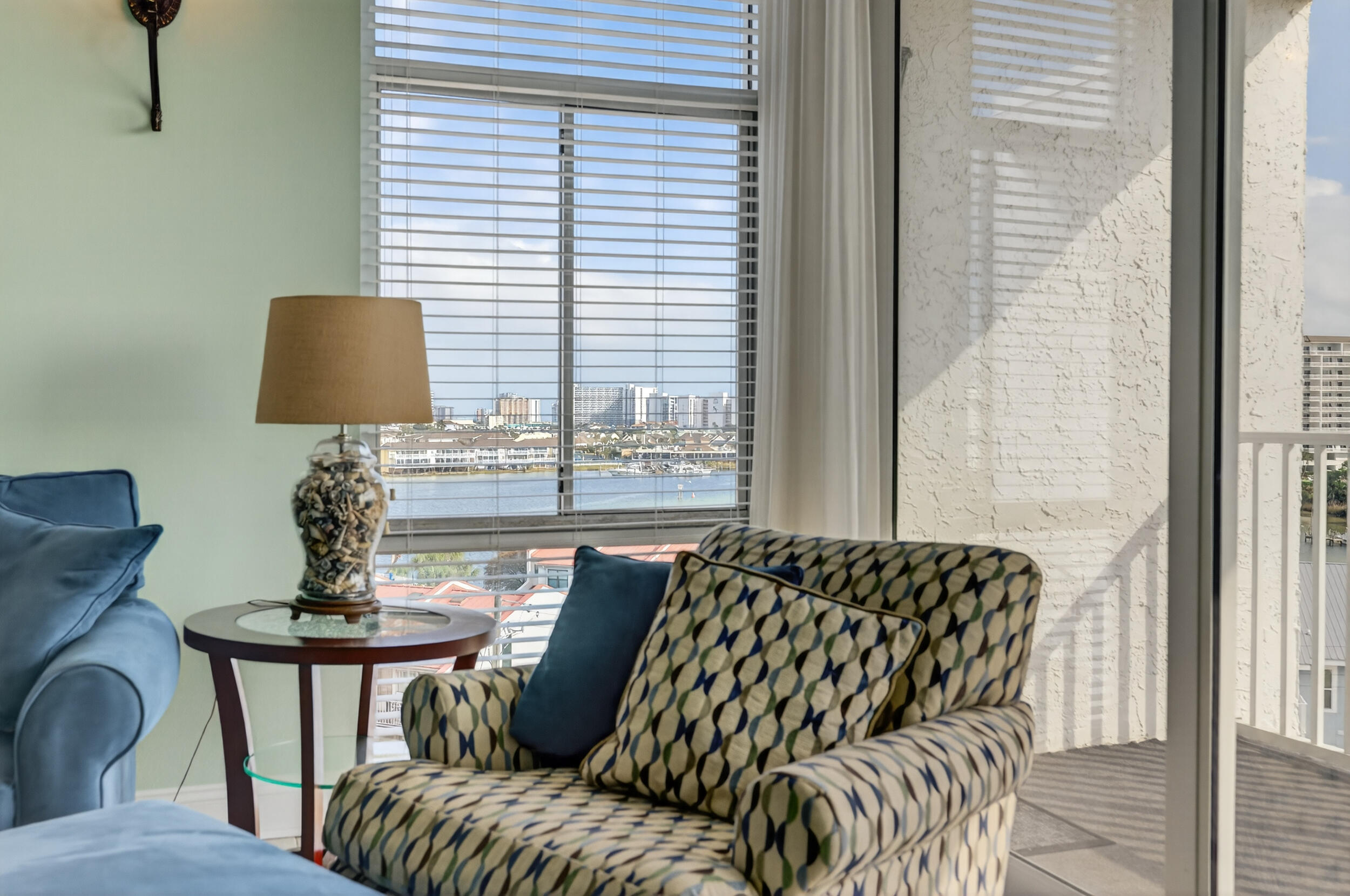 30 Moreno Point Road, Unit 702A Destin, FL 32541 - Photo 18 of 51 a balcony view with a couch and a potted plant