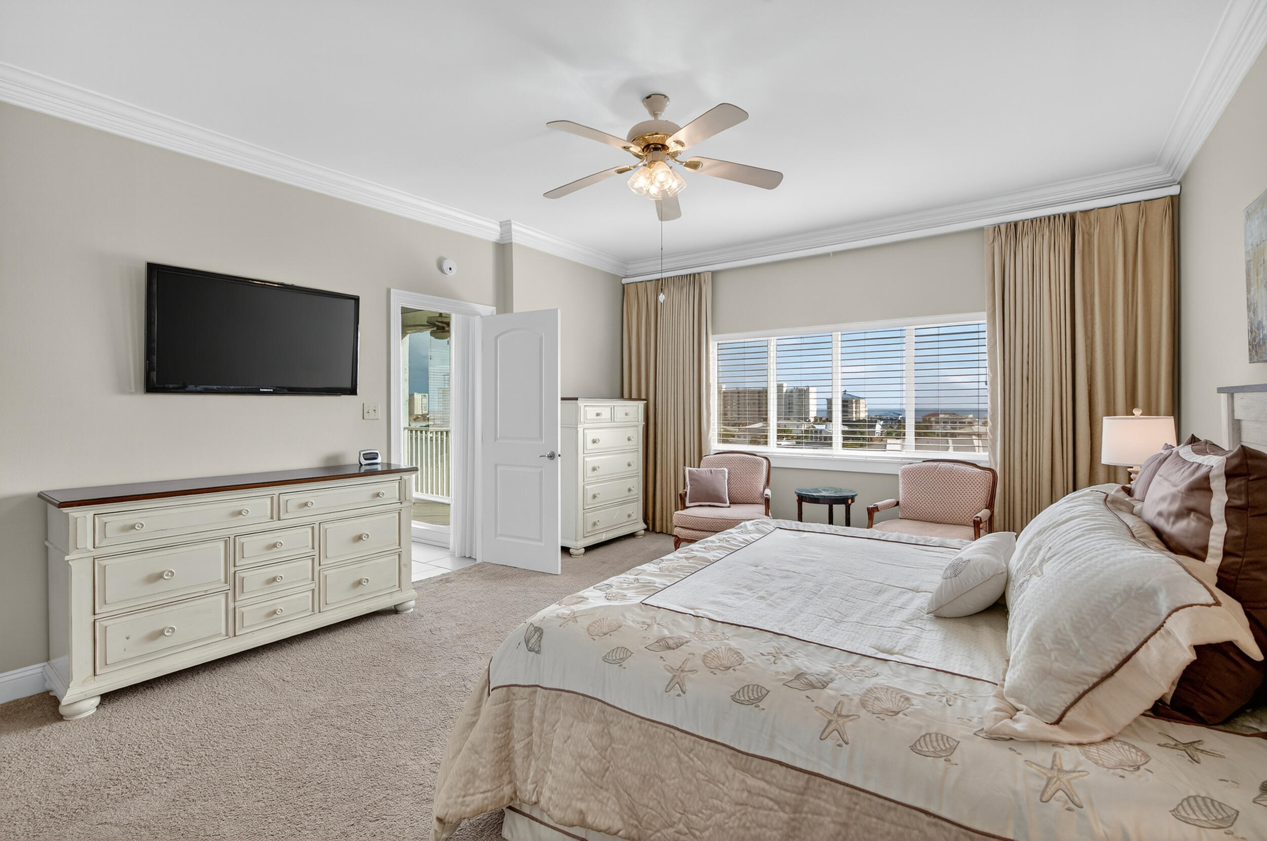 30 Moreno Point Road, Unit 702A Destin, FL 32541 - Photo 28 of 51 a spacious bedroom with a large bed and a flat screen tv