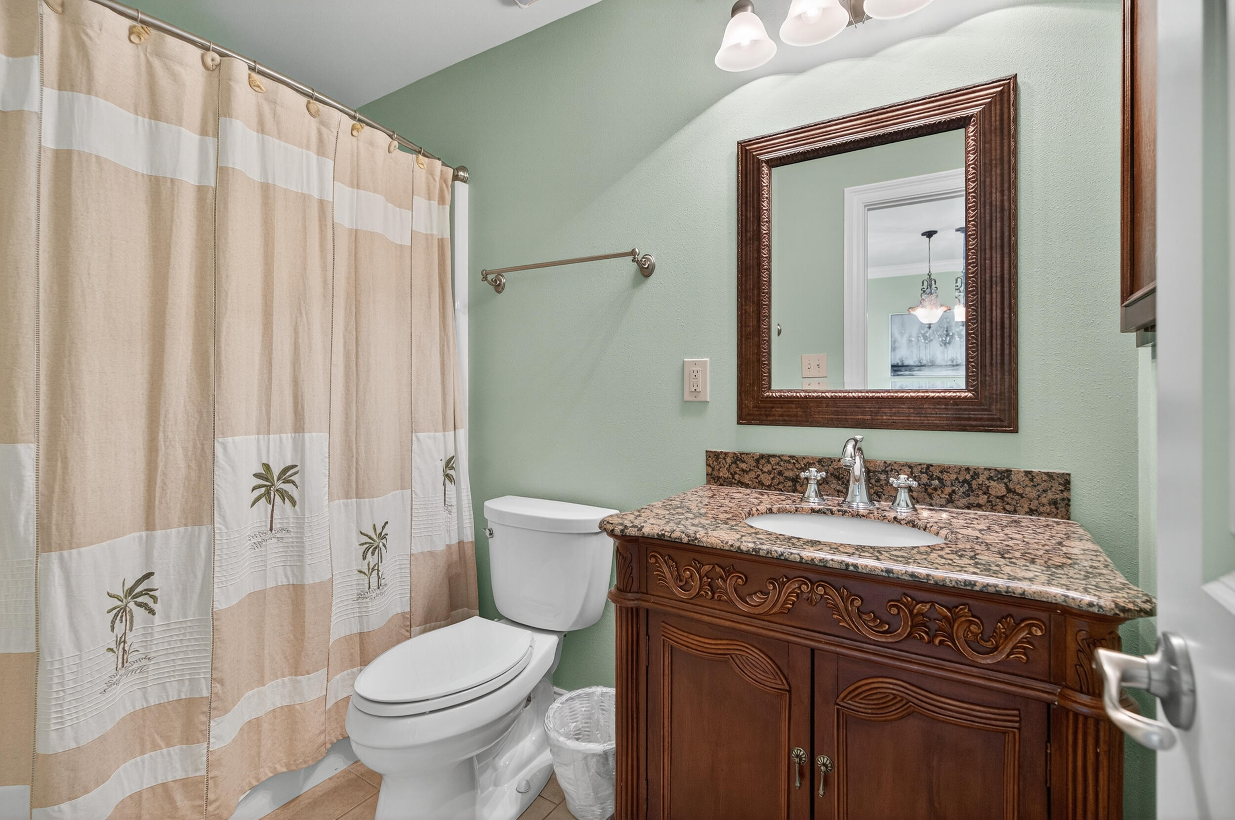 30 Moreno Point Road, Unit 702A Destin, FL 32541 - Photo 34 of 51 a bathroom with a granite countertop toilet sink and mirror