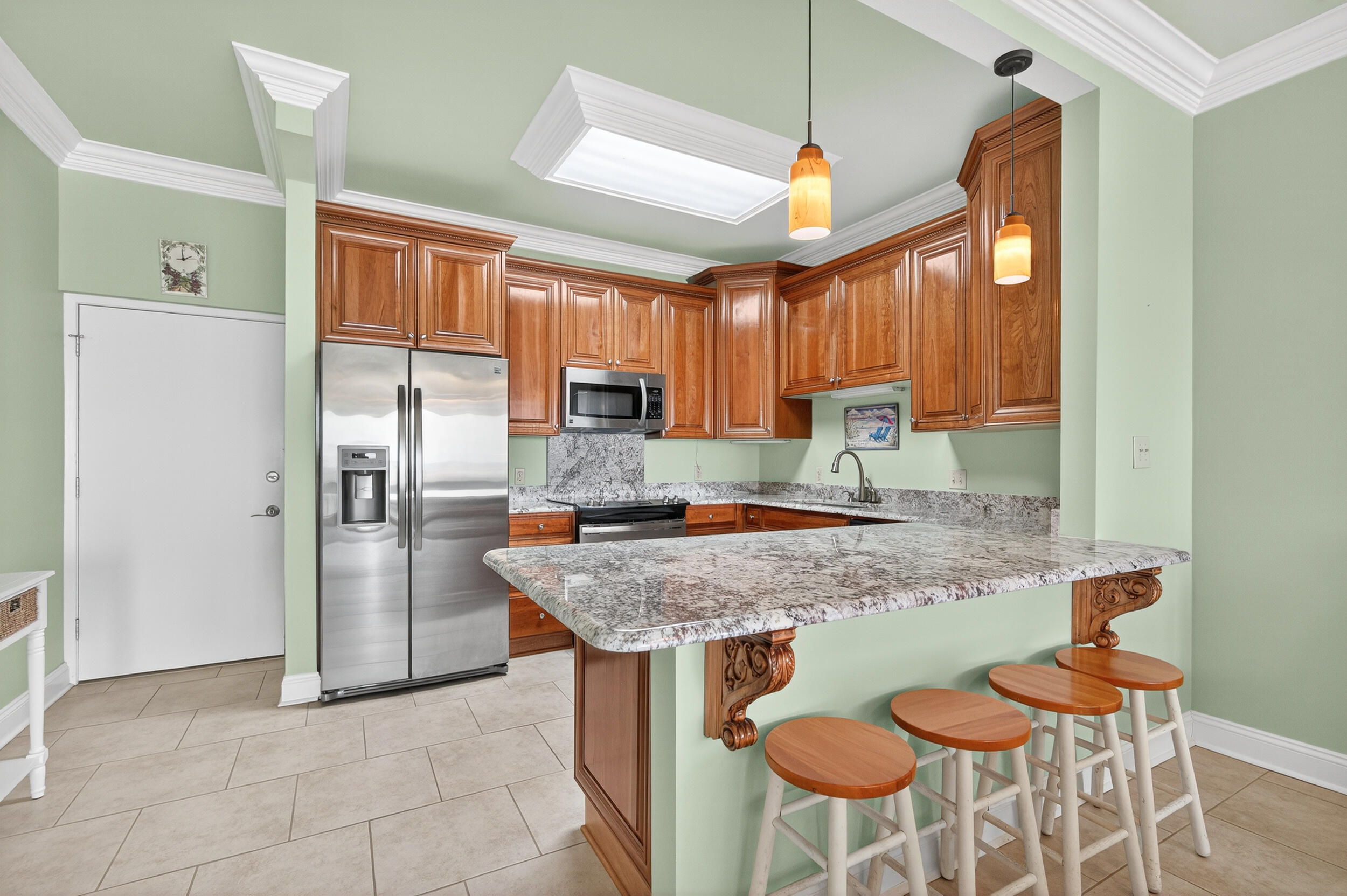 30 Moreno Point Road, Unit 702A Destin, FL 32541 - Photo 9 of 51 a kitchen with stainless steel appliances granite countertop a sink and a refrigerator