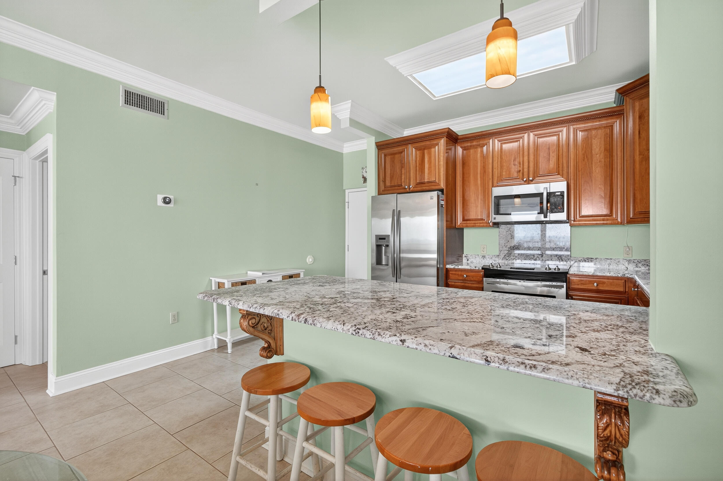 30 Moreno Point Road, Unit 702A Destin, FL 32541 - Photo 10 of 51 a kitchen with stainless steel appliances granite countertop a sink a stove and a wooden cabinets