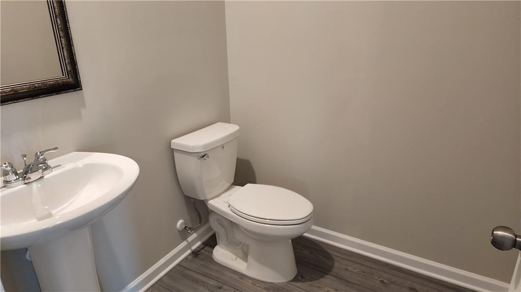 400 Grey Falcon Avenue Braselton, GA 30517 - Photo 15 of 31 a white toilet sitting next to a bathroom sink