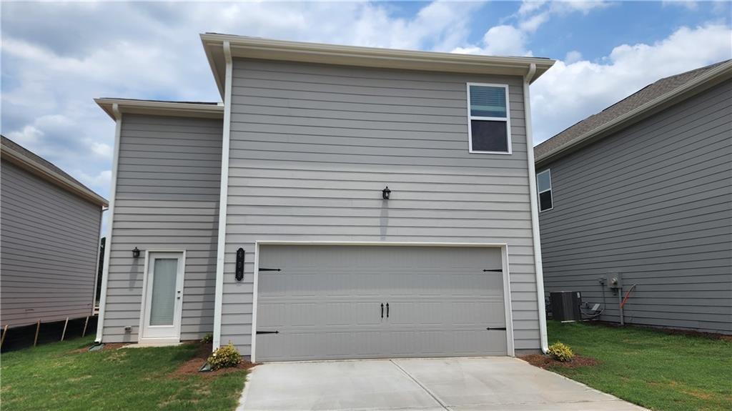 400 Grey Falcon Avenue Braselton, GA 30517 - Photo 17 of 31 a front view of a house with a garage