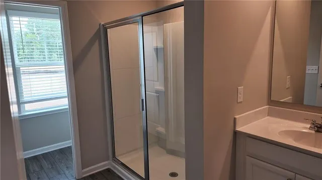 a bathroom with a shower and a sink