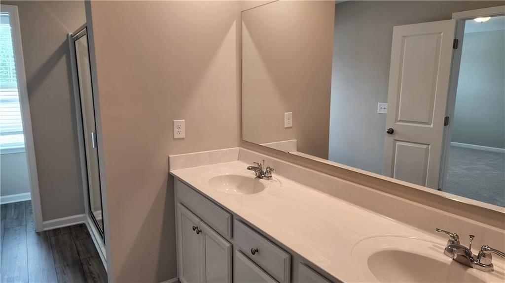 400 Grey Falcon Avenue Braselton, GA 30517 - Photo 24 of 31 a bathroom with a sink and a mirror