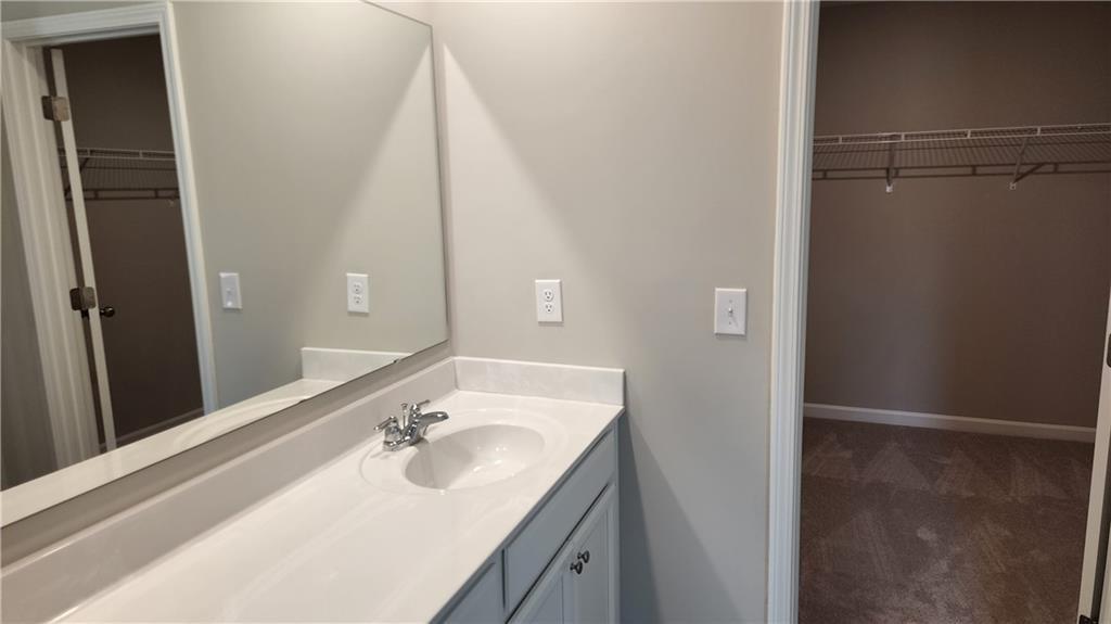 400 Grey Falcon Avenue Braselton, GA 30517 - Photo 25 of 31 a bathroom with a sink and a mirror