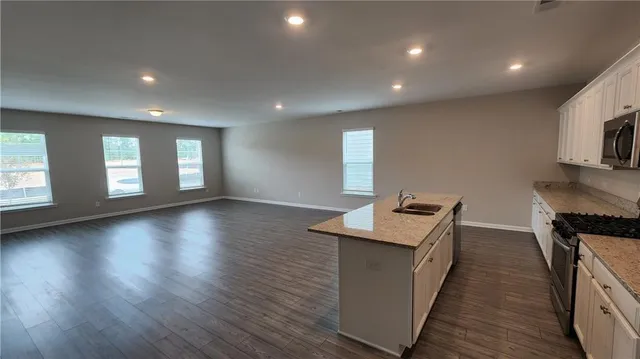 a kitchen with sink and wooden floor