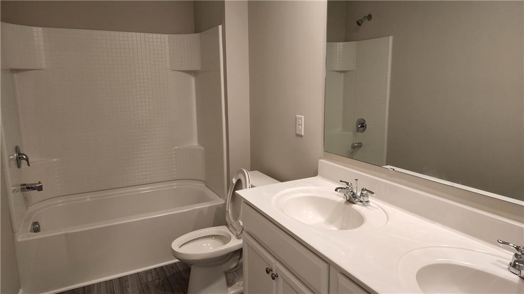 400 Grey Falcon Avenue Braselton, GA 30517 - Photo 31 of 31 a bathroom with a sink toilet vanity and shower