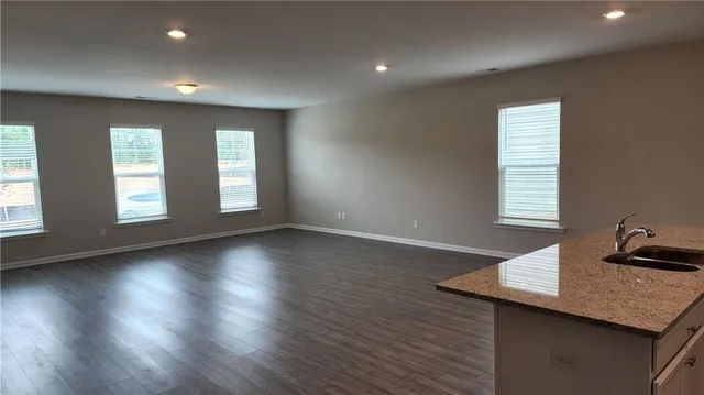 a view of wooden floor and windows in a room