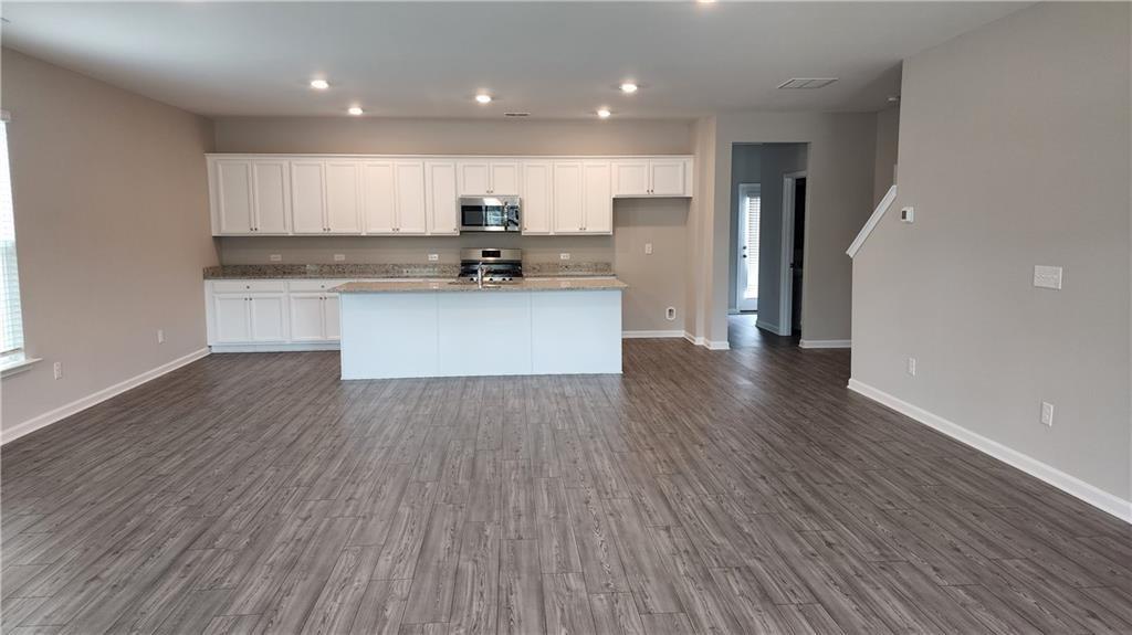 400 Grey Falcon Avenue Braselton, GA 30517 - Photo 9 of 31 a view of kitchen with wooden floor and electronic appliances