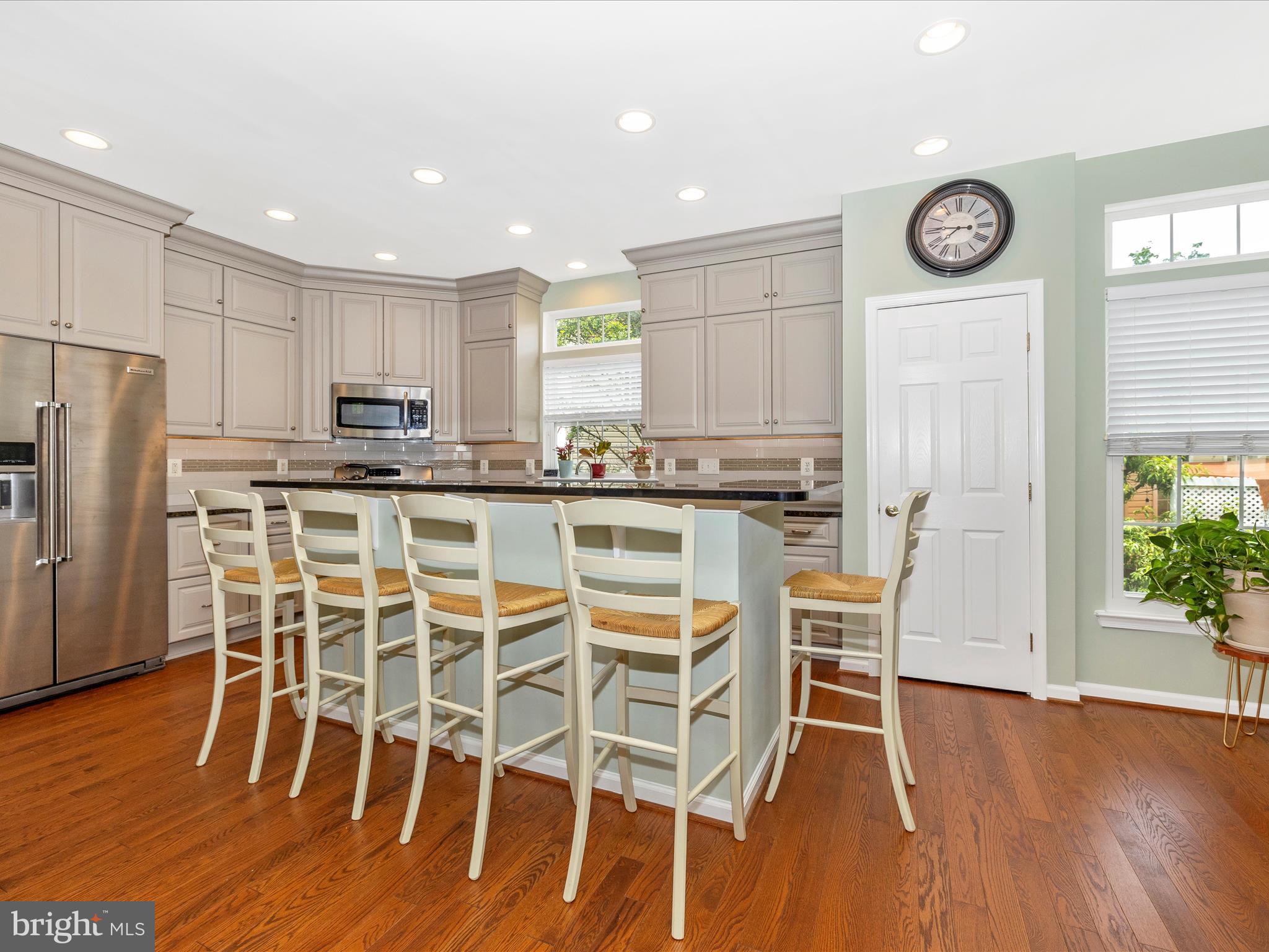 6470 Saddlebrook Lane Frederick, MD 21701 - Photo 16 of 74 a kitchen with stainless steel appliances a table chairs refrigerator and microwave