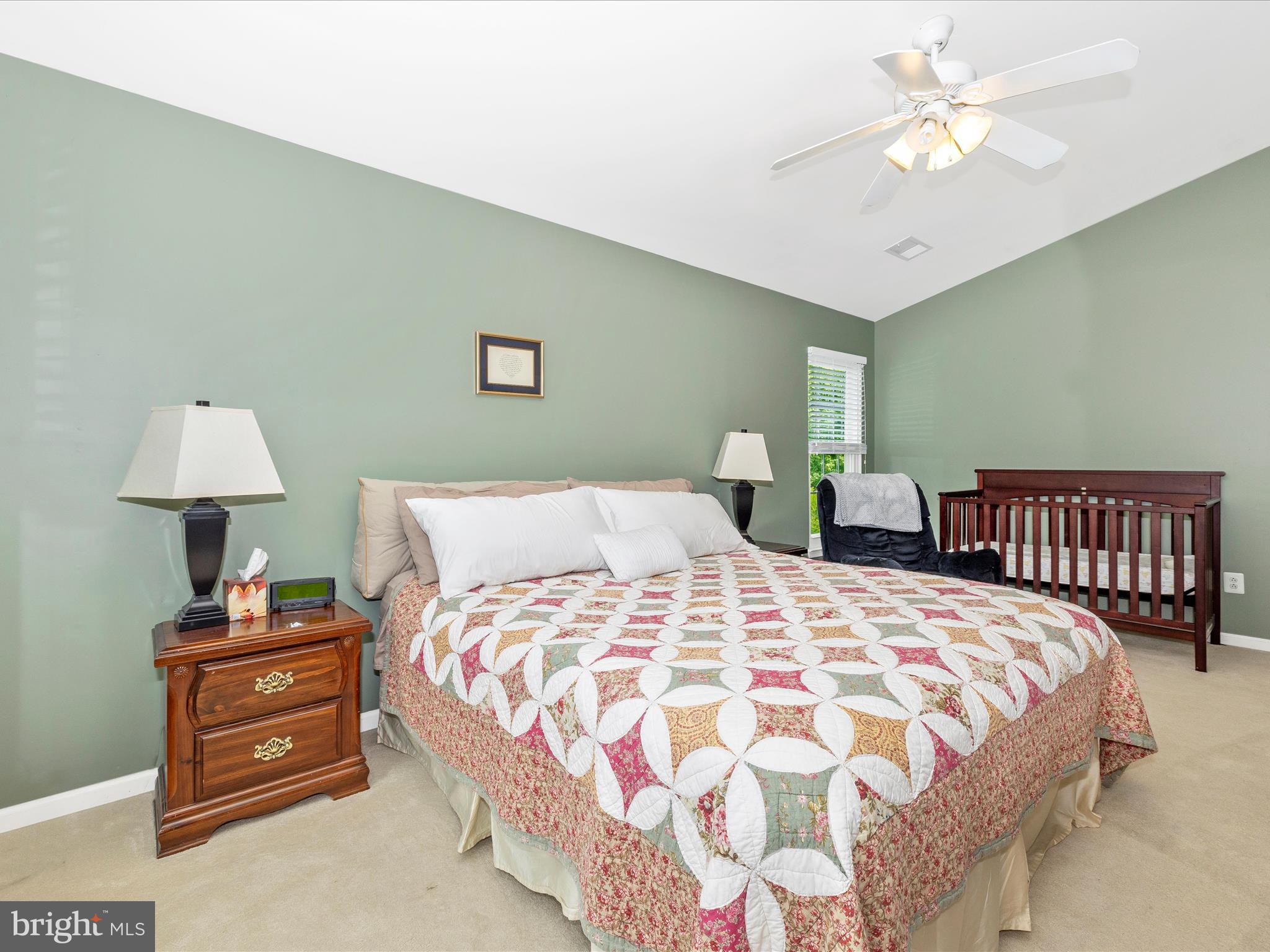 6470 Saddlebrook Lane Frederick, MD 21701 - Photo 28 of 74 a bedroom with a bed and a lamp