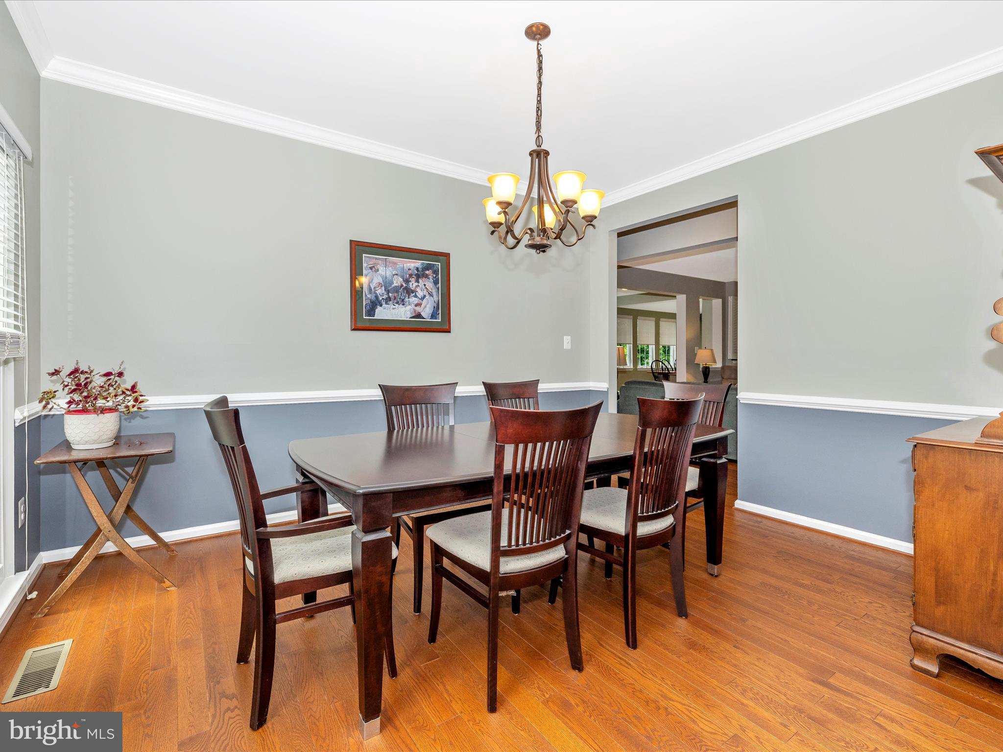 6470 Saddlebrook Lane Frederick, MD 21701 - Photo 10 of 74 a view of a dining room with furniture wooden floor and a chandelier