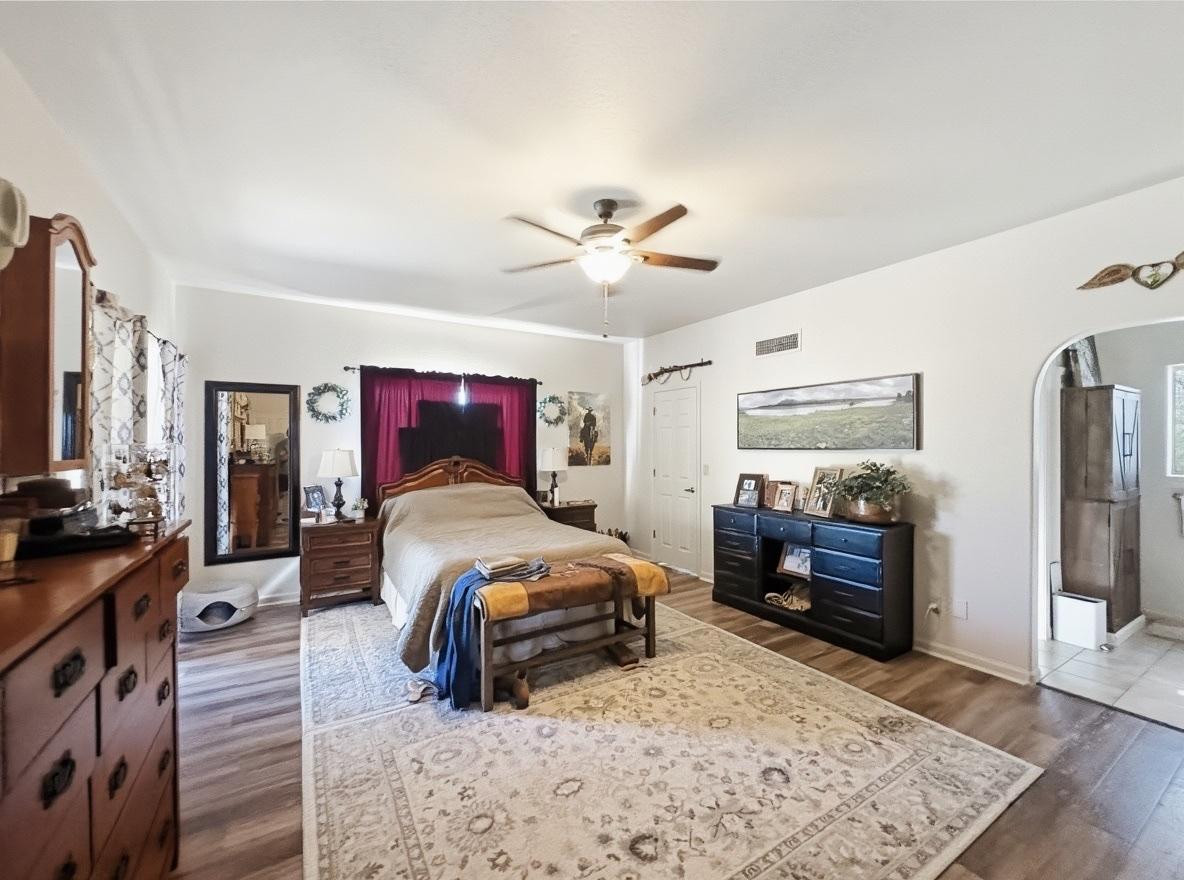 1033 East Irvine Road, Unit A Phoenix, AZ 85086 - Photo 12 of 26 a bedroom with furniture a bed and a flat screen tv