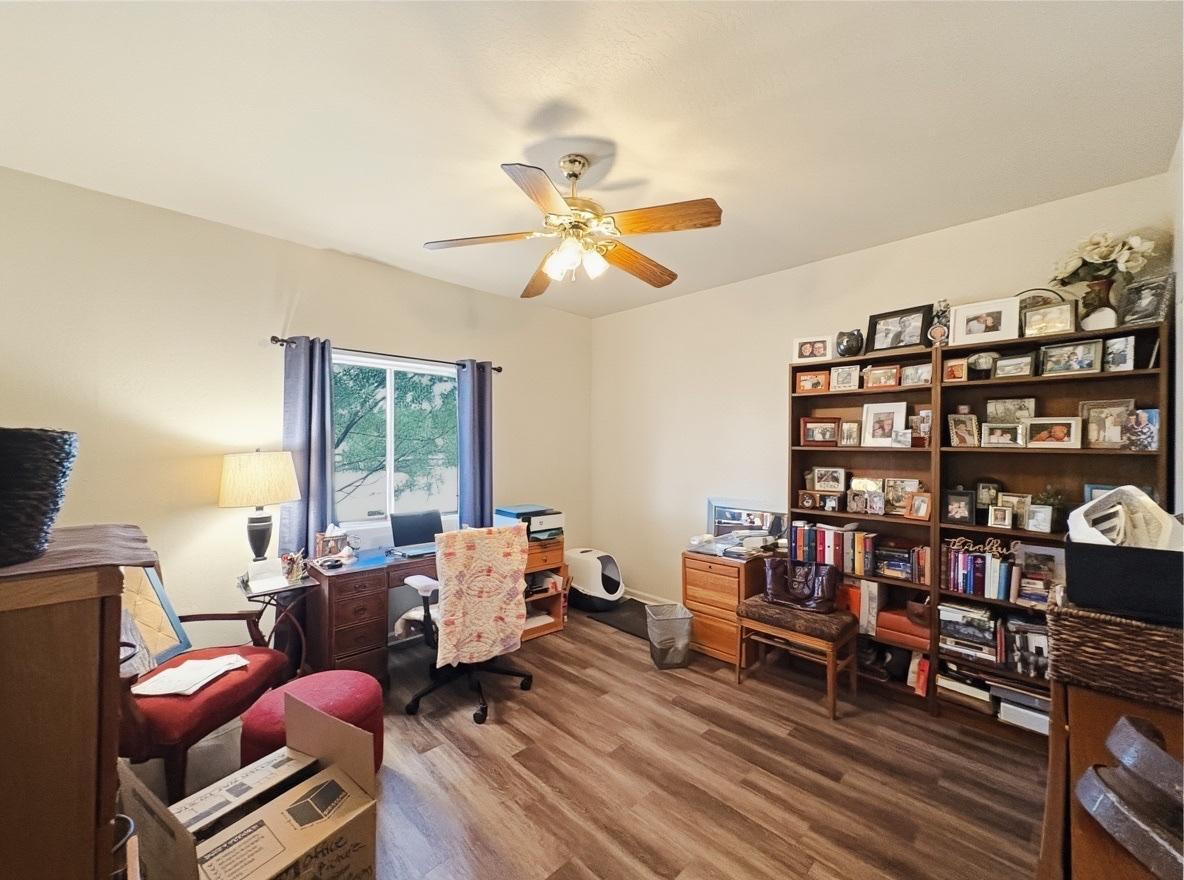 1033 East Irvine Road, Unit A Phoenix, AZ 85086 - Photo 20 of 26 a living room with furniture a bookshelf and a window