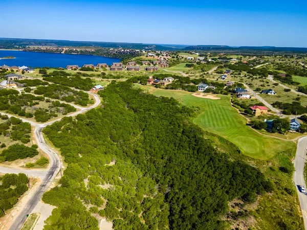 an aerial view of house with yard and lake