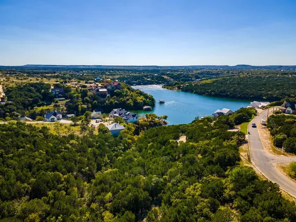 an aerial view of a houses with a lake view