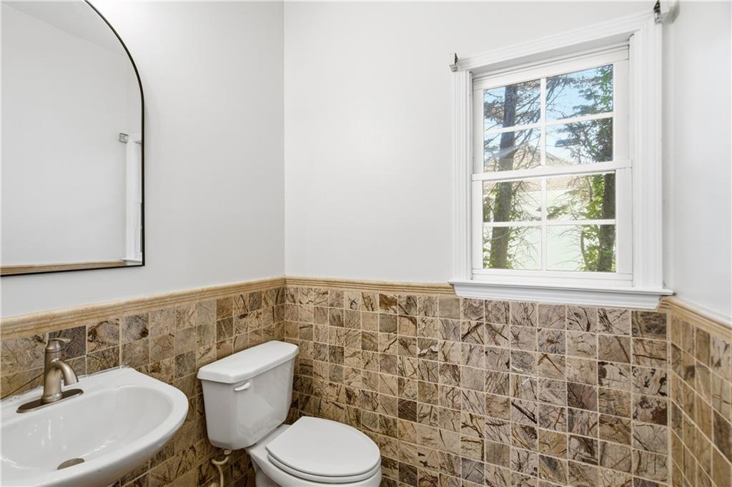110 Mayes Farm Road Northwest Marietta, GA 30064 - Photo 42 of 49 a bathroom with a toilet a sink and a mirror
