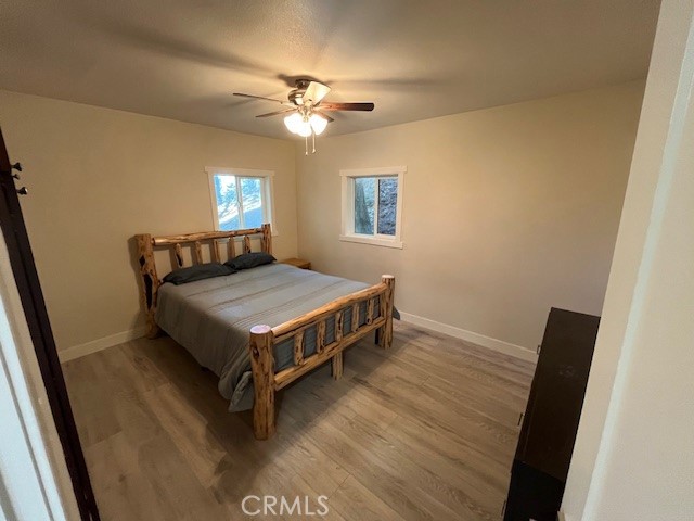 601 Sunderland Court Lake Arrowhead, CA 92352 - Photo 12 of 18 a bedroom with a bed and a chandelier
