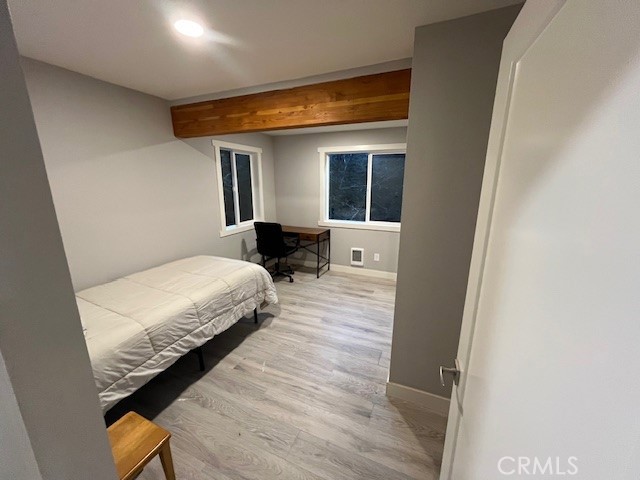 601 Sunderland Court Lake Arrowhead, CA 92352 - Photo 13 of 18 a bedroom with a bed and wooden floor