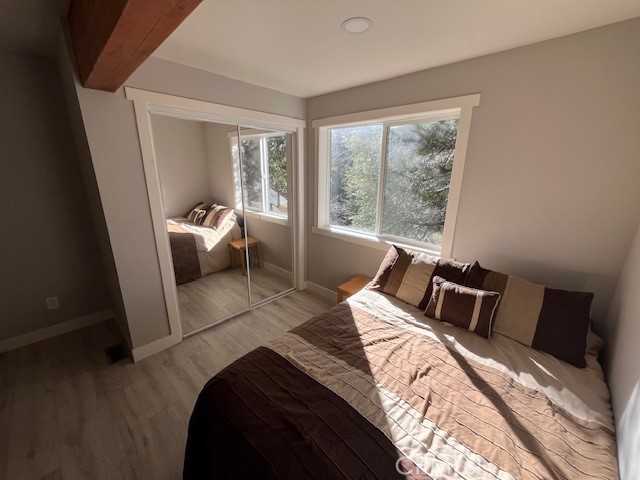 601 Sunderland Court Lake Arrowhead, CA 92352 - Photo 15 of 18 a bed sitting in a bedroom next to a window