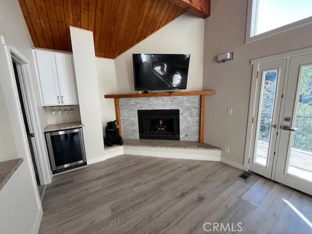 a kitchen with a wooden floor and a refrigerator