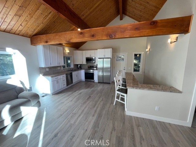 601 Sunderland Court Lake Arrowhead, CA 92352 - Photo 9 of 18 a kitchen with a wooden floor and a refrigerator