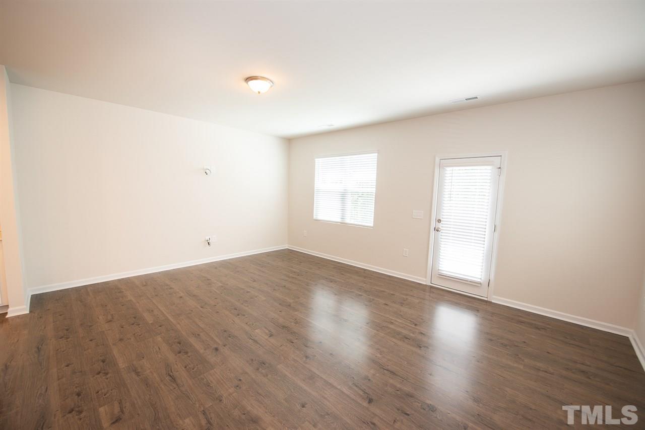 3616 Water Mist Lane, Unit 33 Raleigh, NC 27604 - Photo 3 of 26 an empty room with wooden floor and windows