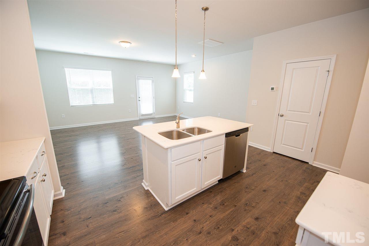 3616 Water Mist Lane, Unit 33 Raleigh, NC 27604 - Photo 8 of 26 a kitchen with a sink cabinets and wooden floor