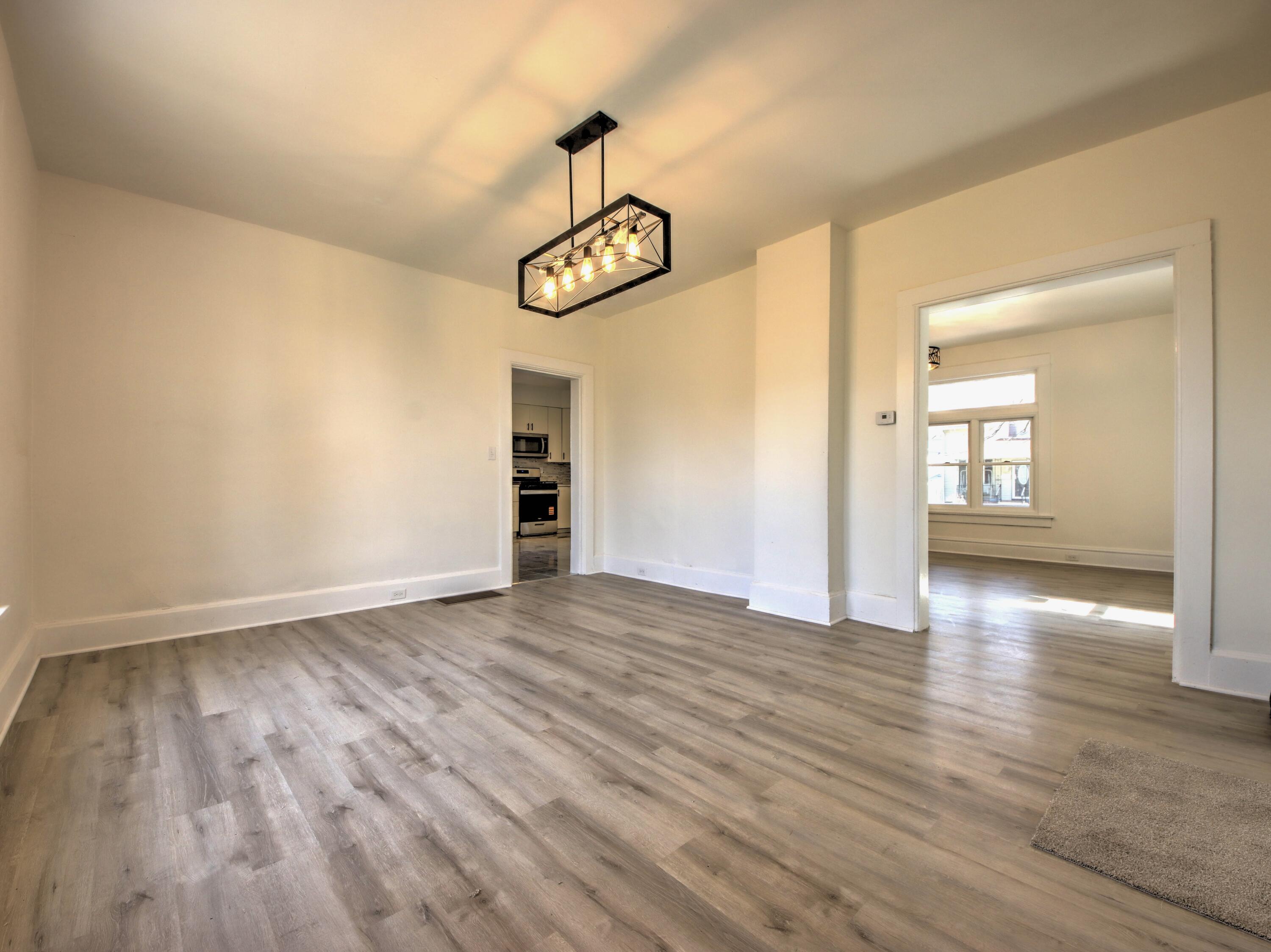 508 F Street La Porte, IN 46350 - Photo 11 of 52 a view of an empty room with wooden floor and window