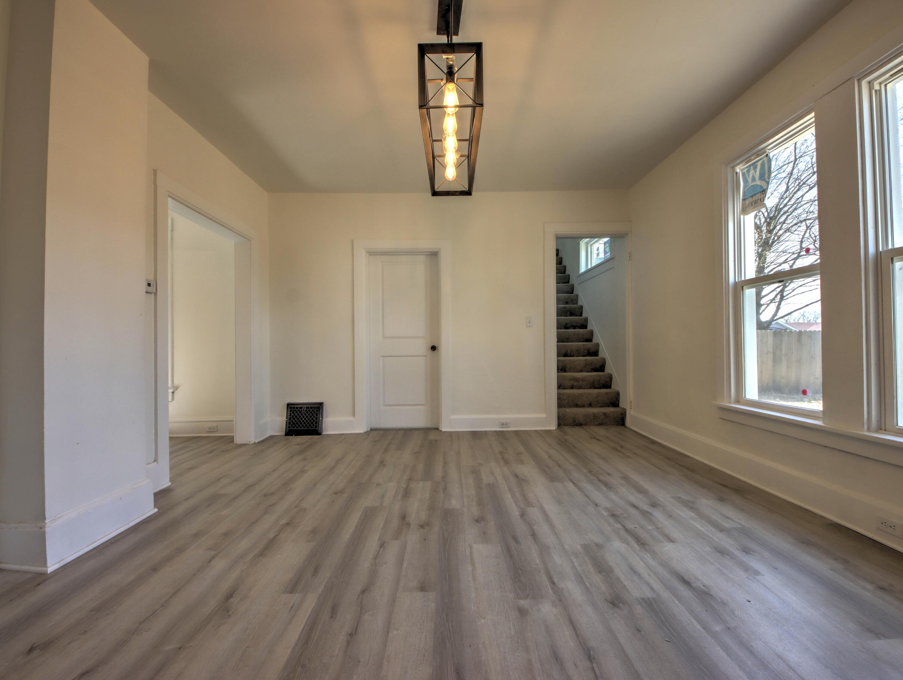 508 F Street La Porte, IN 46350 - Photo 12 of 52 an empty room with wooden floor cabinet and windows